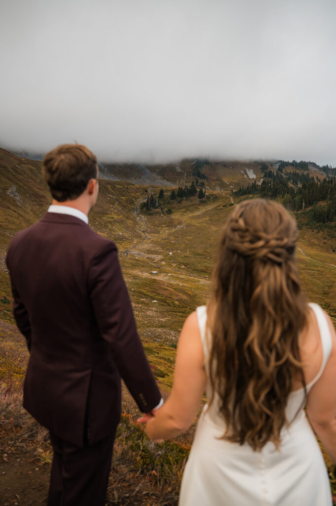 Cozy and candid elopement moment during chilly Mt. Rainier hike