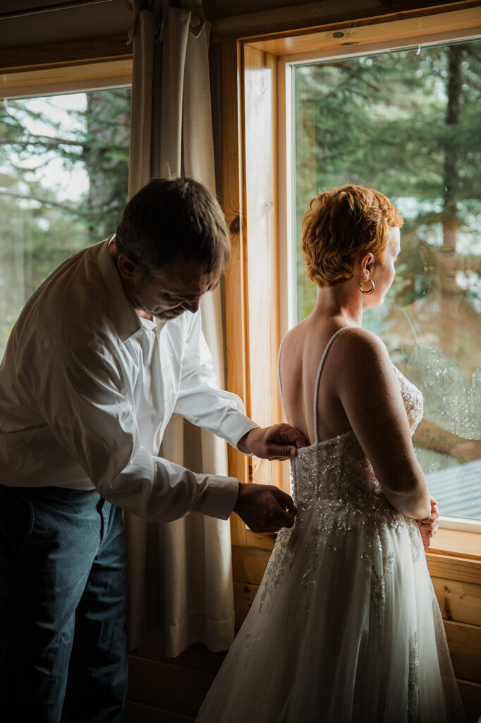 Couple getting ready together during their Seward Alaska elopement morning