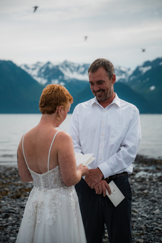 Bride and groom exchanging vows on the coast during their Seward Alaska elopement