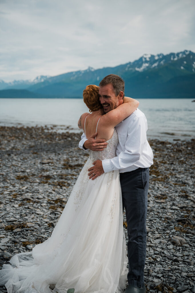 Candid laughter between bride and groom on the Seward Alaska coast