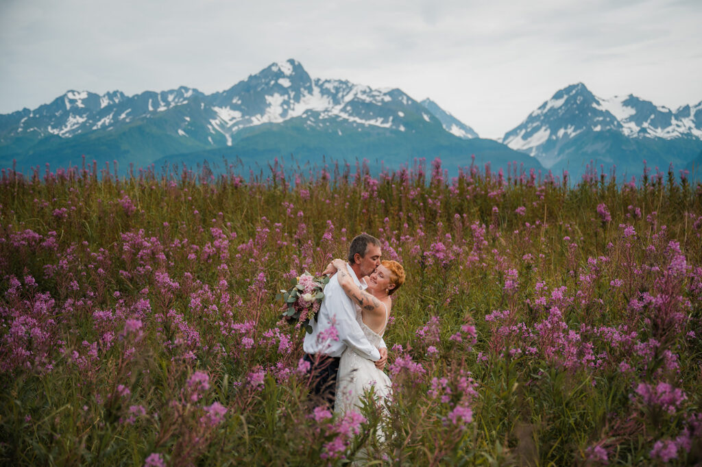 Romantic elopement photos in fireweed fields at Salted Roots Seward Alaska