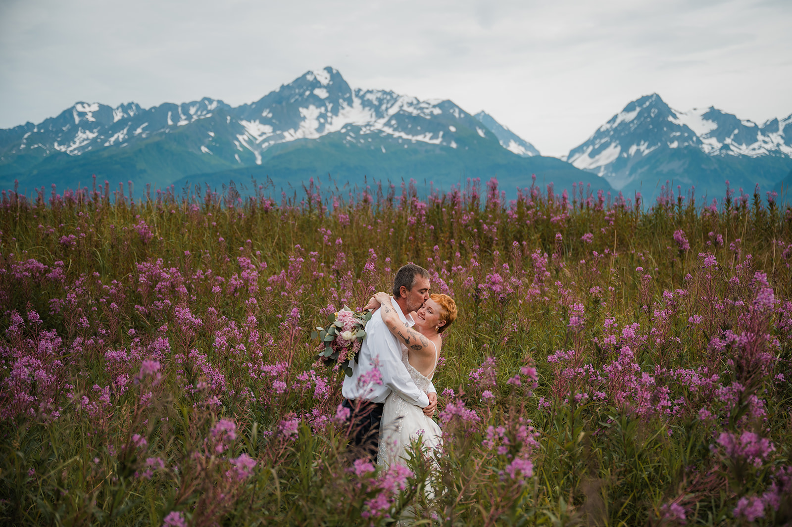 Romantic elopement photos in fireweed fields at Salted Roots Seward Alaska