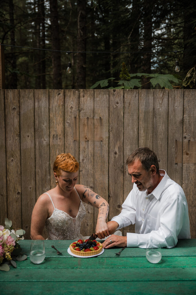 Hannah and Thad celebrating with fruit tart after their Seward Alaska elopement
